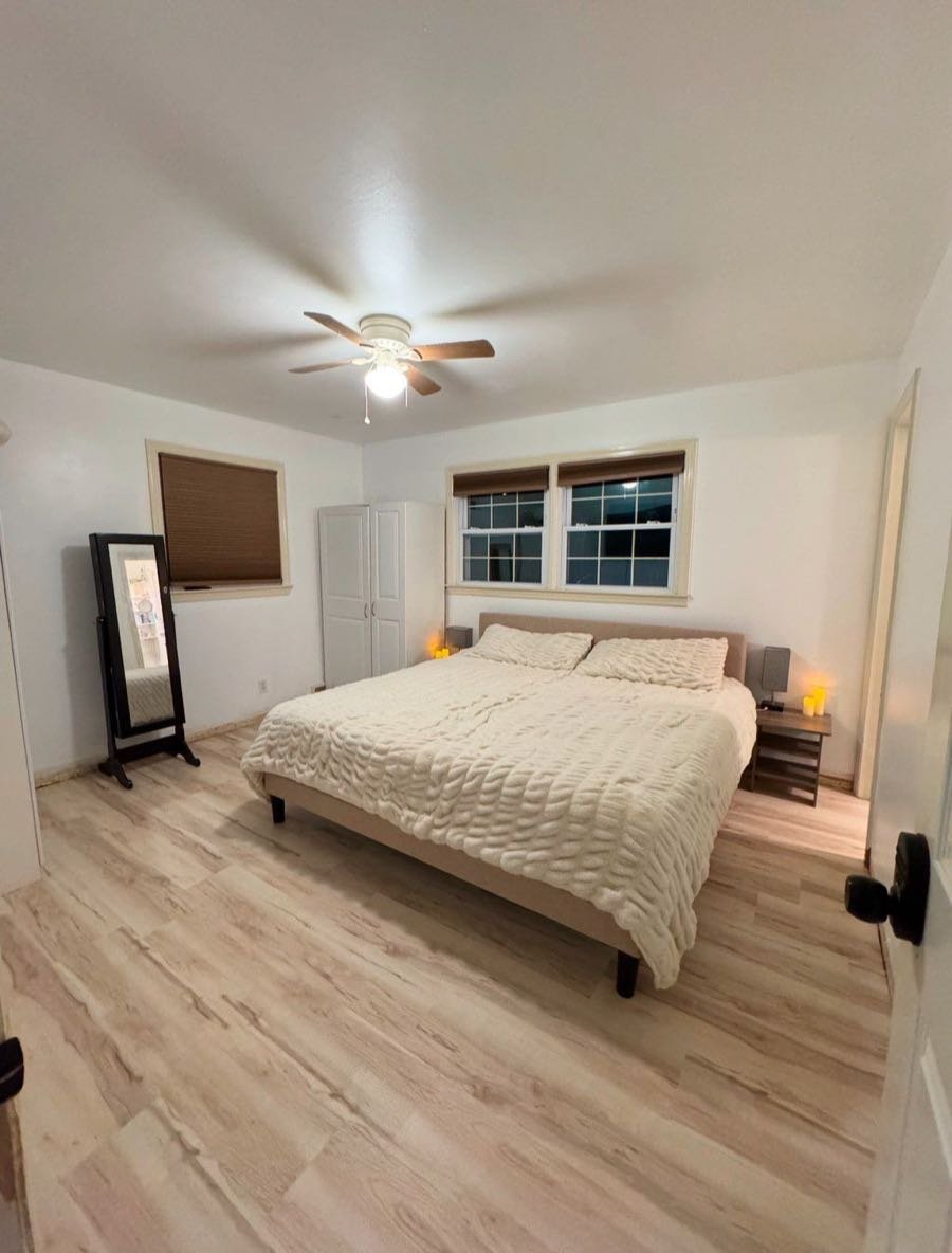 Bedroom with a king bed and light wood floors