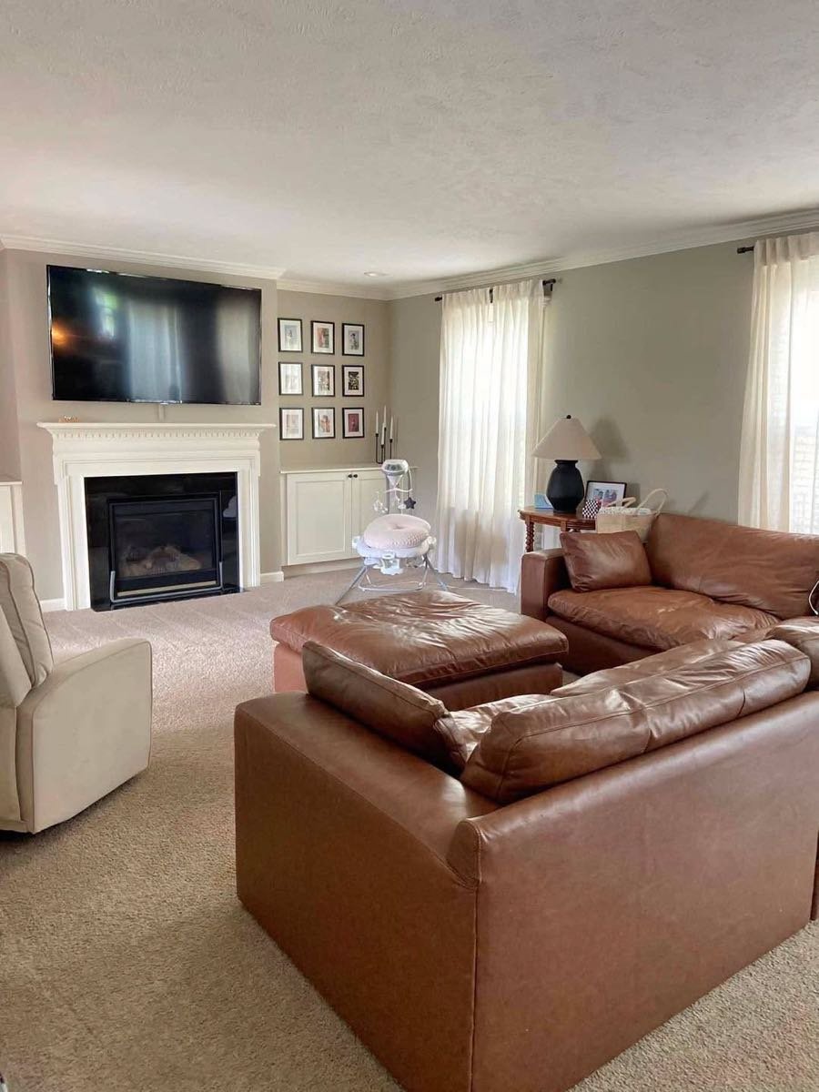 Living room with a leather sectional and fireplace